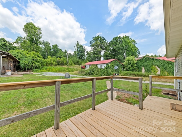 wooden terrace with a lawn