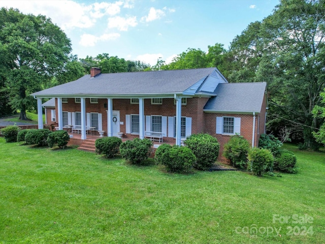 view of front of property with a front lawn and covered porch