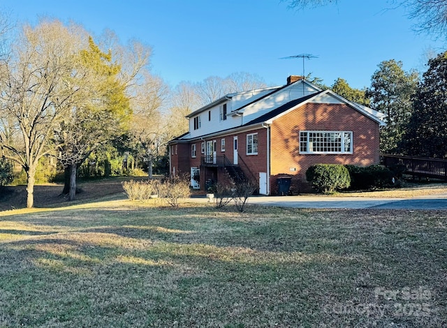 view of side of home featuring a yard