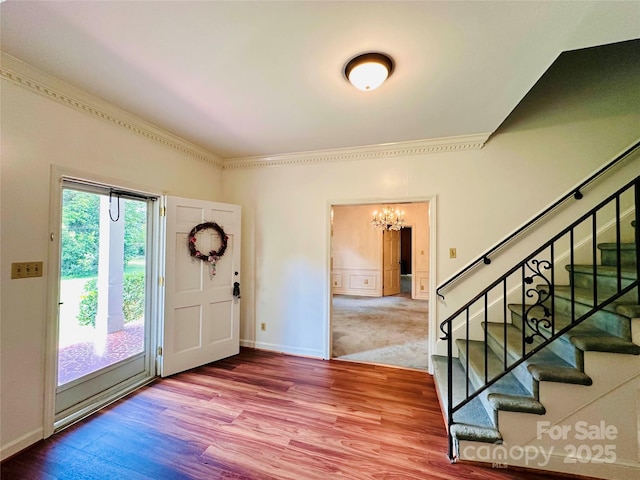 entrance foyer with hardwood / wood-style flooring and a notable chandelier