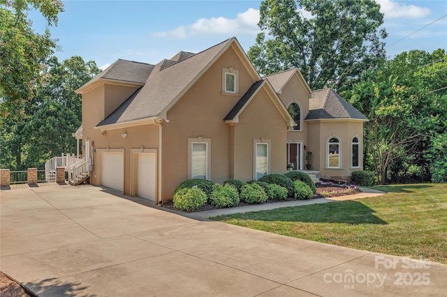 view of front of home with a garage and a front lawn