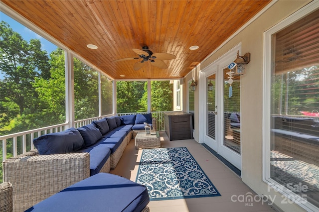 sunroom / solarium featuring ceiling fan and wood ceiling