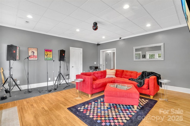 living room featuring crown molding and hardwood / wood-style flooring