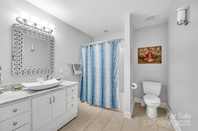 full bathroom with tile patterned floors, toilet, shower / bath combo with shower curtain, and vanity