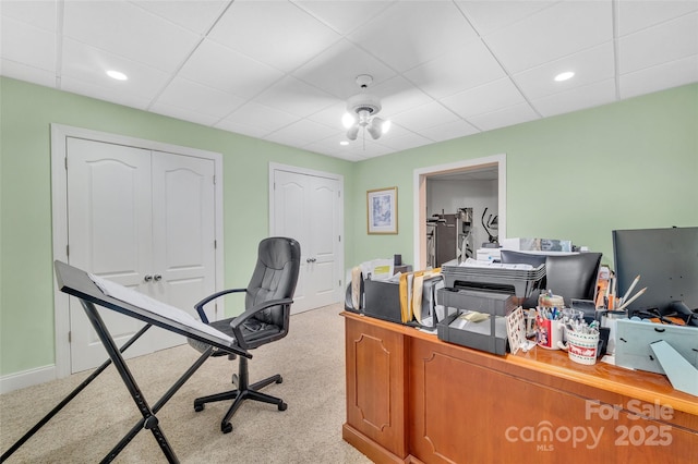 carpeted office space featuring a drop ceiling