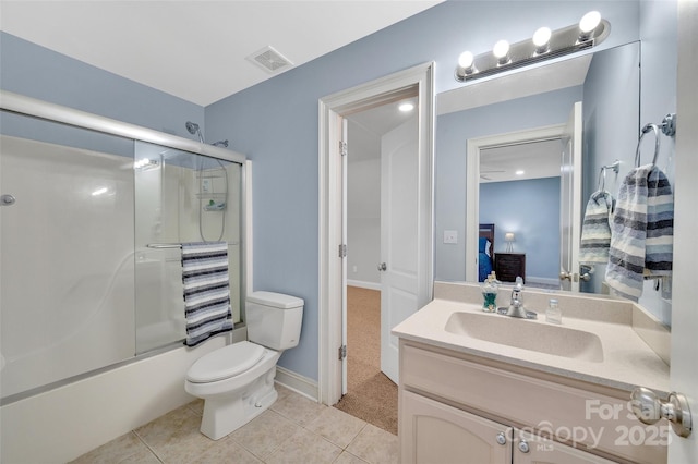 full bathroom featuring vanity, toilet, tile patterned floors, and bath / shower combo with glass door