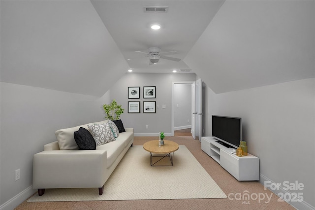 carpeted living room featuring ceiling fan and vaulted ceiling