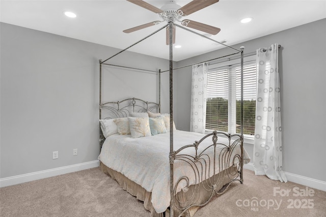 carpeted bedroom with multiple windows and ceiling fan