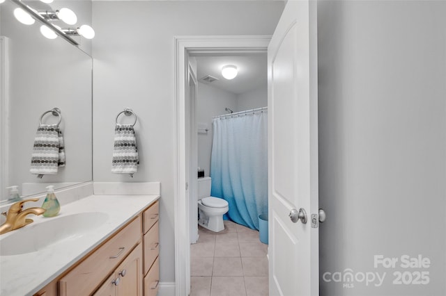 bathroom featuring tile patterned flooring, vanity, walk in shower, and toilet