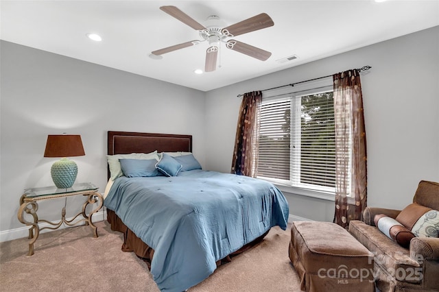 bedroom featuring light colored carpet and ceiling fan