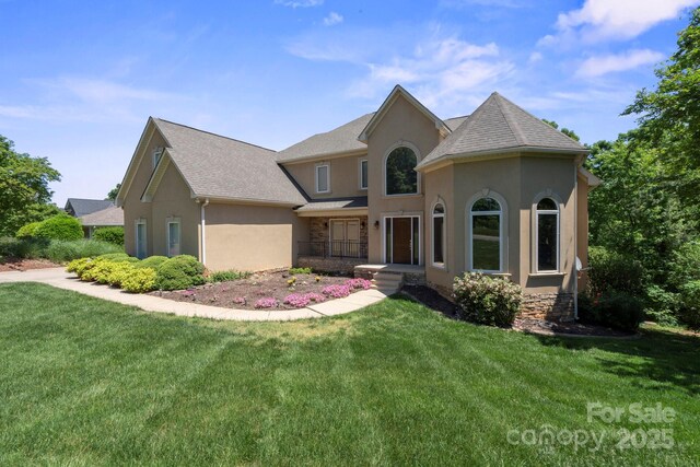 122 Long Cove Ln, Mooresville, NC 28117 - view of front facade with roof with shingles, stone siding, a front yard, and stucco siding