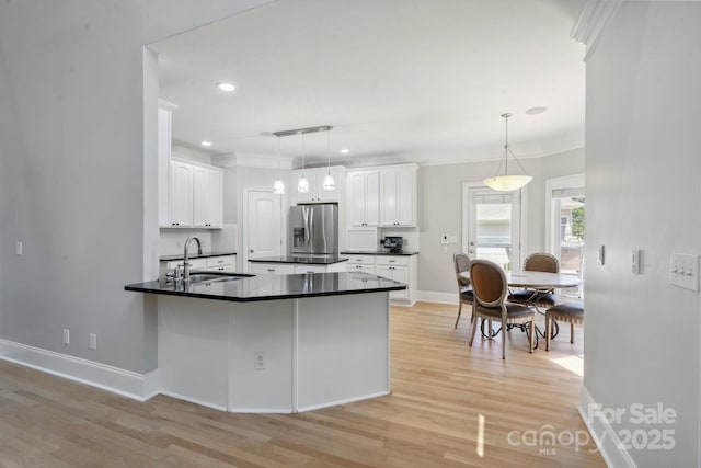 122 Long Cove Ln, Mooresville, NC 28117 - kitchen featuring dark countertops, light wood-type flooring, white cabinets, stainless steel fridge with ice dispenser, and a sink