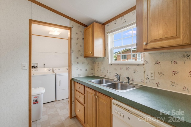 kitchen featuring vaulted ceiling, washer and dryer, white dishwasher, and sink