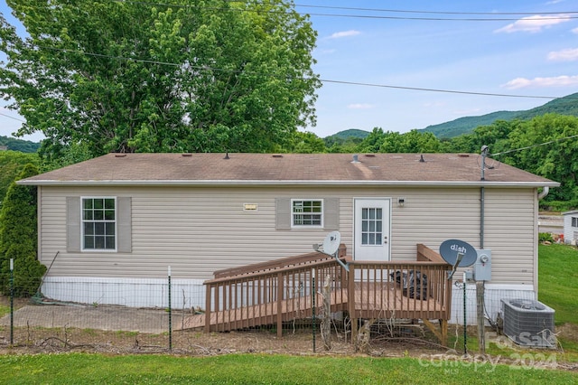 back of house featuring a deck with mountain view and central air condition unit