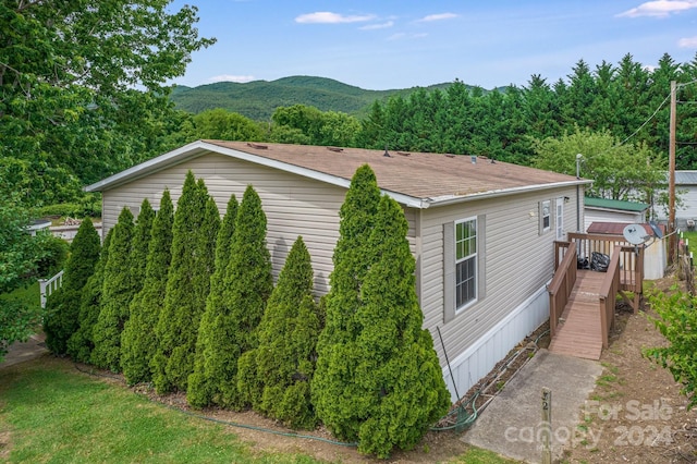 view of property exterior featuring a deck with mountain view