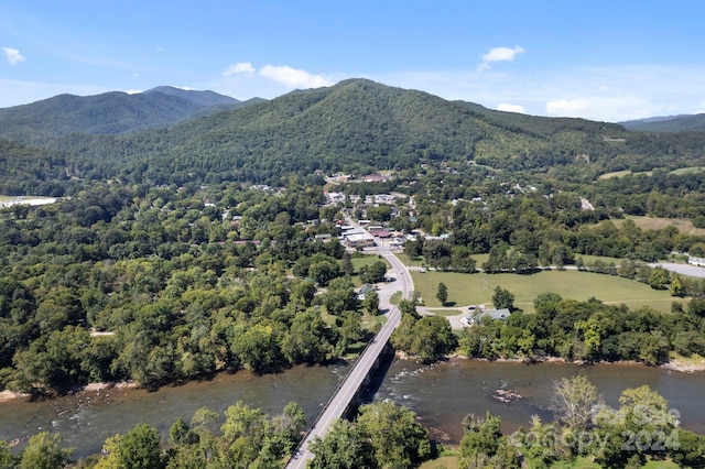 drone / aerial view featuring a water and mountain view