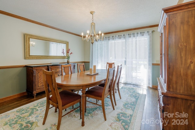 dining room with an inviting chandelier, a wealth of natural light, crown molding, and dark hardwood / wood-style floors