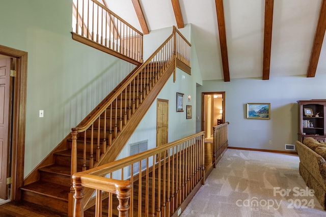 staircase featuring high vaulted ceiling, carpet floors, and beamed ceiling