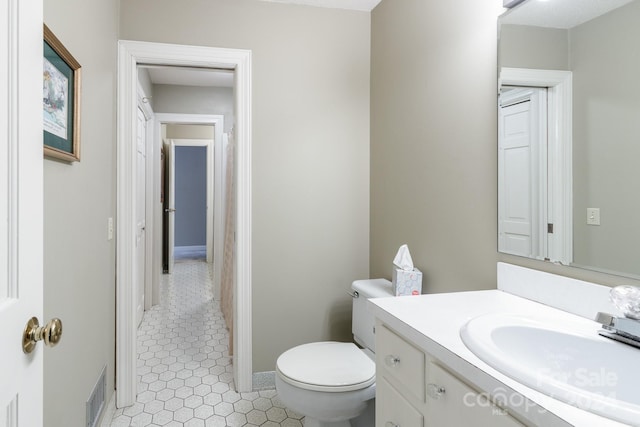 bathroom featuring toilet and vanity