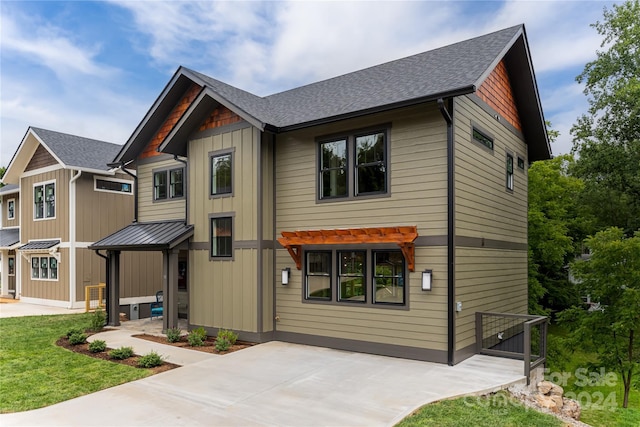 view of front facade featuring a front yard and a patio area