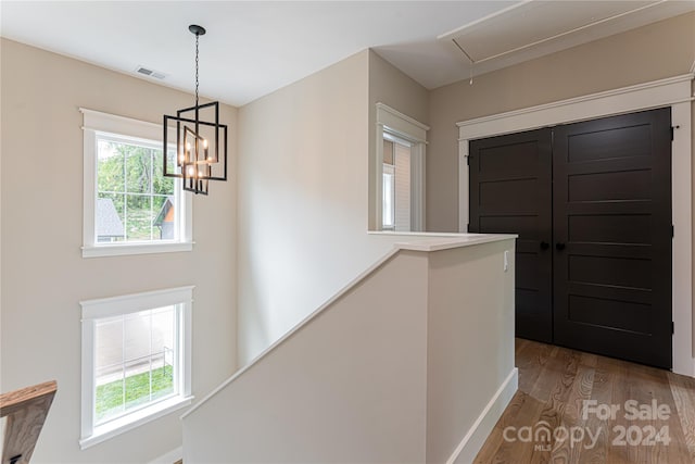 corridor with light hardwood / wood-style floors