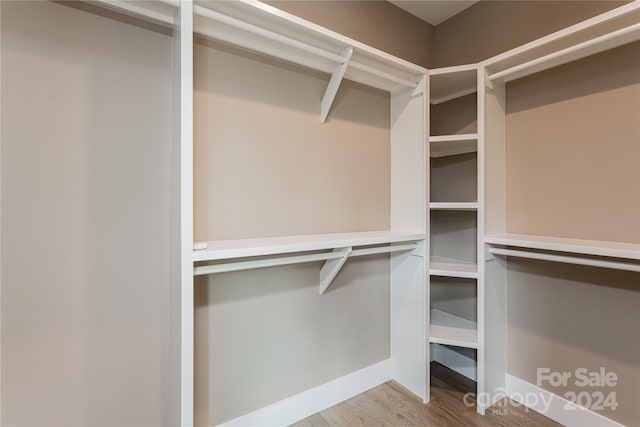 spacious closet with light hardwood / wood-style floors