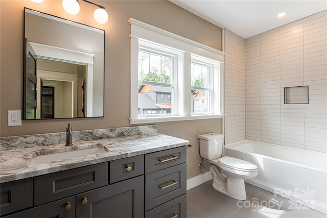 full bathroom featuring vanity, tiled shower / bath, toilet, and tile patterned floors