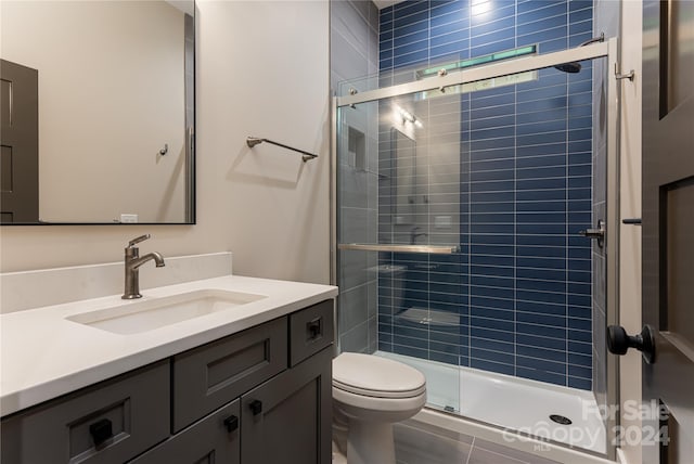 bathroom with vanity, toilet, and walk in shower