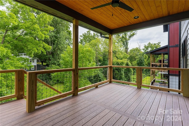 wooden deck featuring ceiling fan