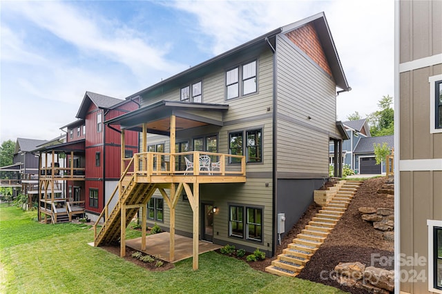 back of house with a patio, a yard, and a wooden deck