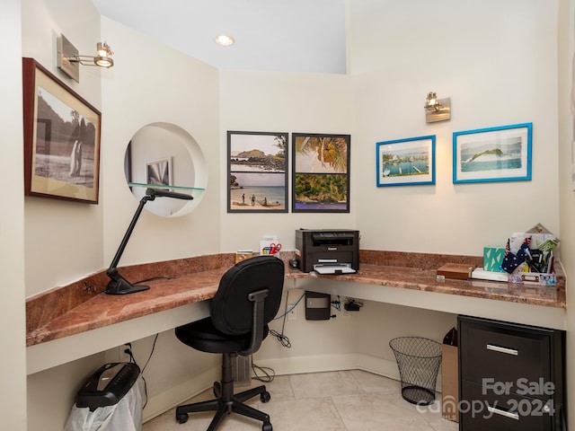 office space with light tile patterned flooring and built in desk