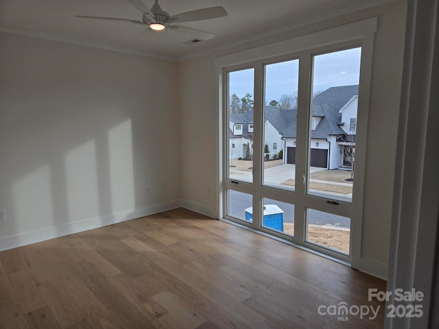 spare room featuring crown molding, hardwood / wood-style flooring, and ceiling fan