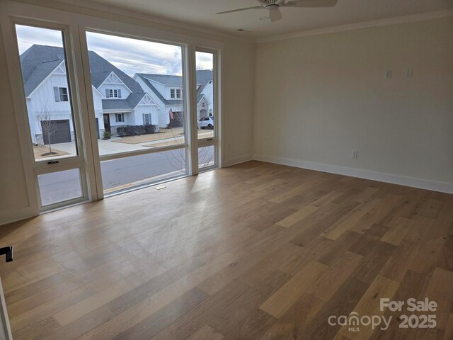 unfurnished room with hardwood / wood-style flooring, crown molding, and ceiling fan