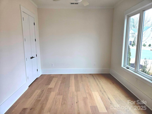 empty room with light hardwood / wood-style flooring and ceiling fan