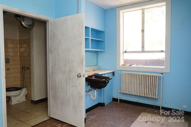 bathroom with toilet and radiator