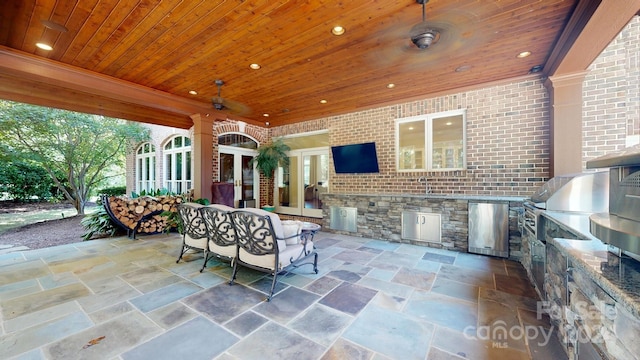 view of patio / terrace featuring grilling area, sink, ceiling fan, and exterior kitchen