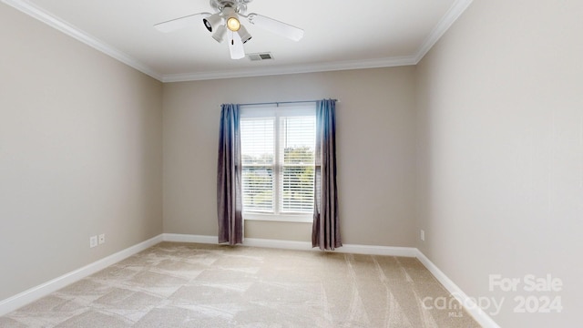 carpeted empty room with ornamental molding and ceiling fan