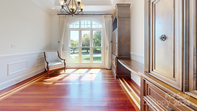 unfurnished room with ornamental molding, dark hardwood / wood-style floors, and a notable chandelier