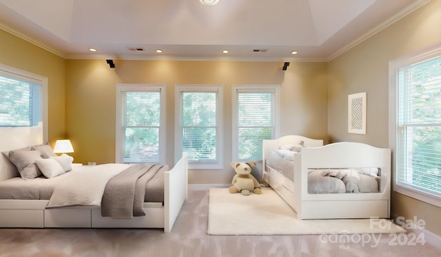 carpeted bedroom with lofted ceiling, multiple windows, and crown molding