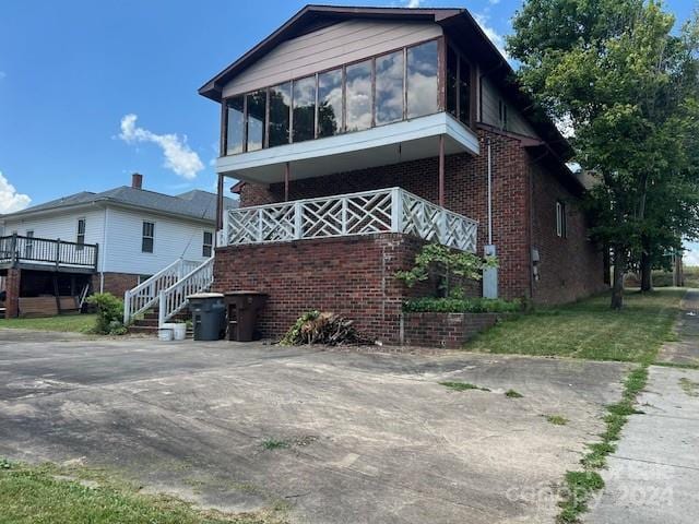 view of front of home featuring a sunroom