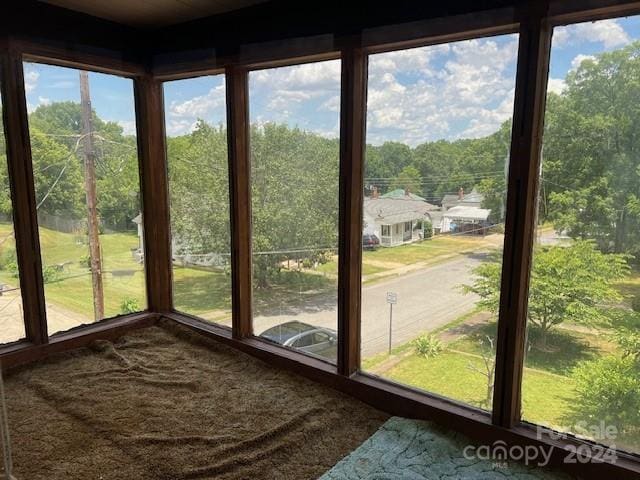 unfurnished sunroom with a wealth of natural light