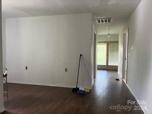 empty room featuring dark hardwood / wood-style flooring