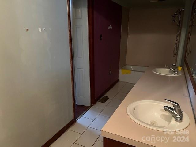 bathroom featuring tile patterned floors, vanity, and a shower