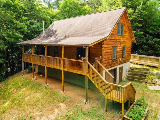 rear view of property featuring a deck and cooling unit