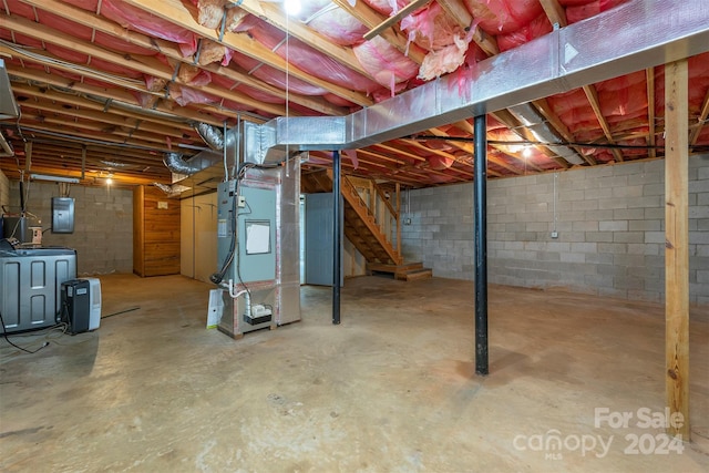 basement featuring washer / dryer, electric panel, and heating unit