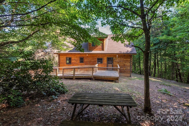 back of house with a wooden deck