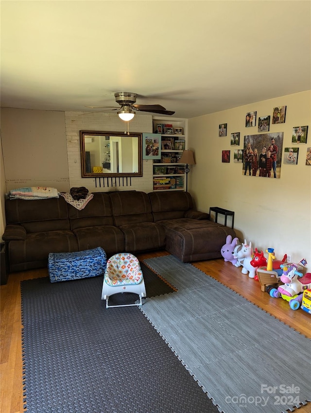 living room with hardwood / wood-style floors and ceiling fan