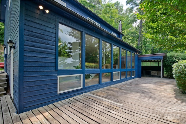 view of side of home with a deck and a sunroom