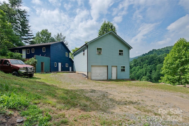 rear view of house with a garage