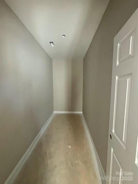 corridor featuring baseboards